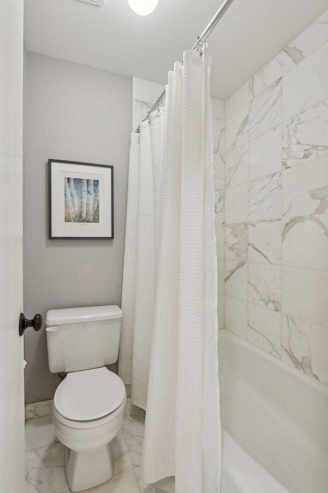 bathroom featuring marble finish floor and toilet