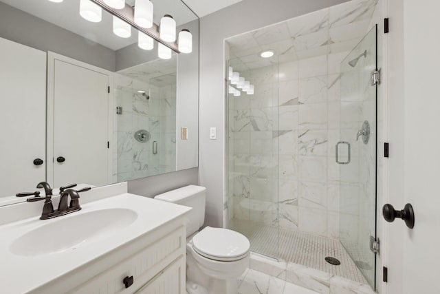 bathroom with vanity, a marble finish shower, and toilet