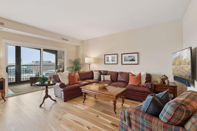 living area with light wood finished floors and visible vents