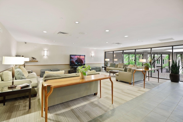 living room with a wainscoted wall, visible vents, and recessed lighting