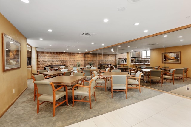 tiled dining area featuring recessed lighting, a brick fireplace, and visible vents