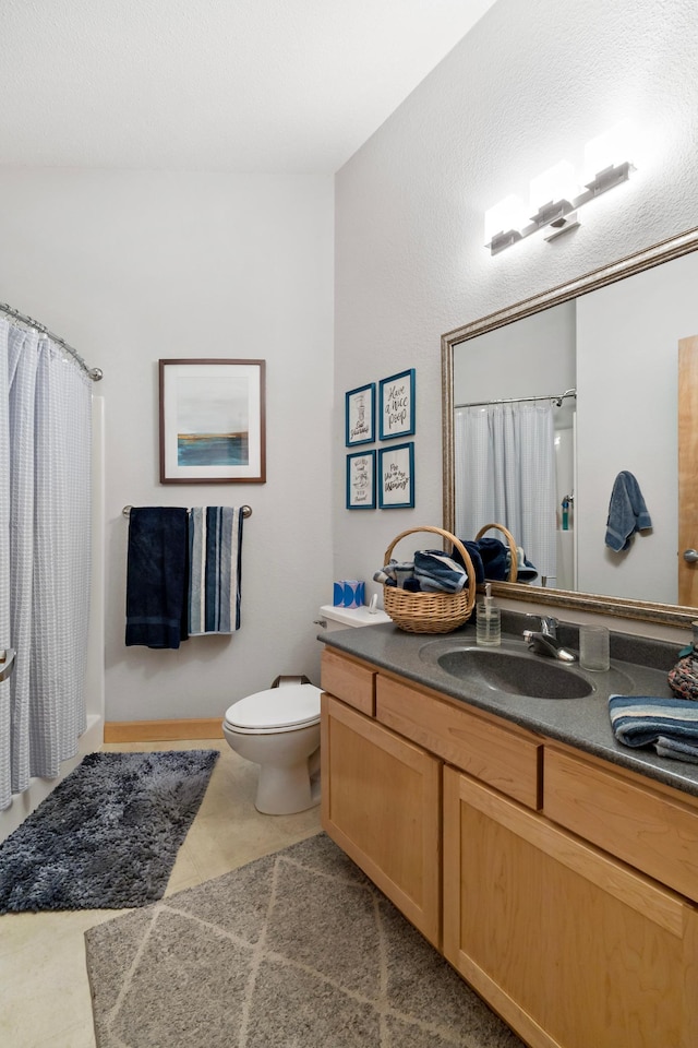 full bath with a shower with curtain, tile patterned flooring, vanity, and toilet