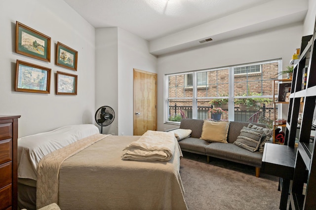 carpeted bedroom featuring visible vents