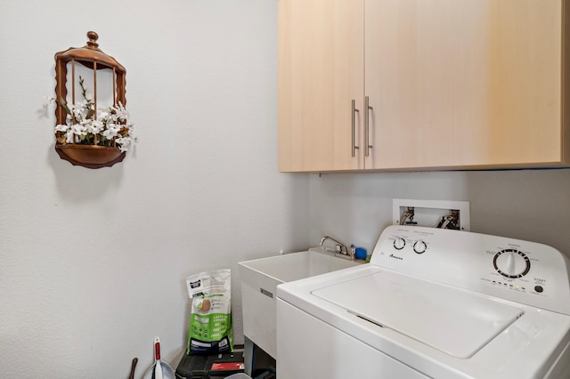 laundry room featuring washer / dryer and cabinet space