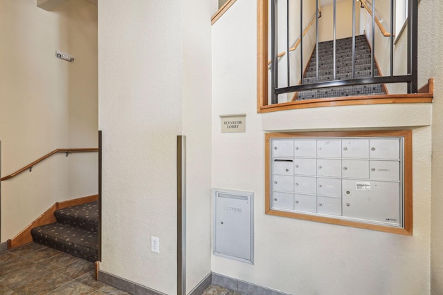 308 18th St Unit 101, Minneapolis, MN 55404 - staircase with baseboards and mail area