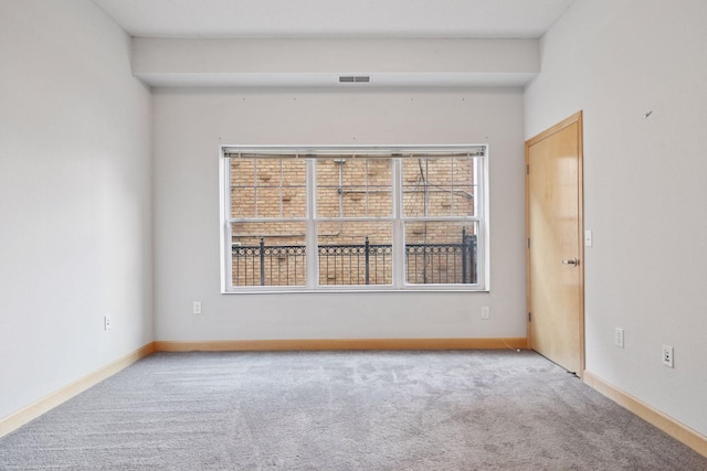 308 18th St Unit 101, Minneapolis, MN 55404 - carpeted spare room featuring baseboards and visible vents