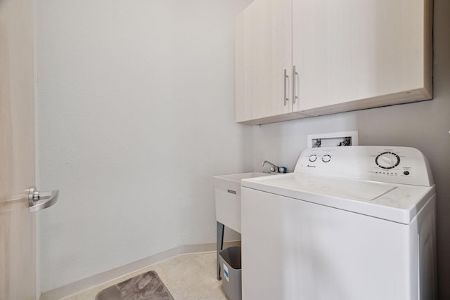 308 18th St Unit 101, Minneapolis, MN 55404 - laundry area with cabinet space, baseboards, washer / dryer, and light tile patterned flooring