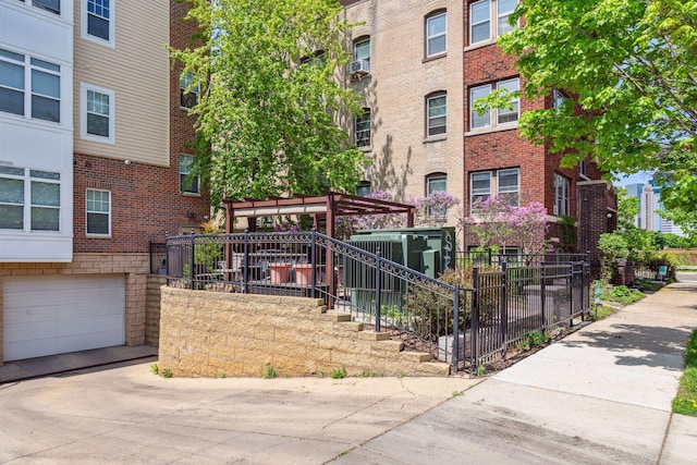 308 18th St Unit 101, Minneapolis, MN 55404 - exterior space with a garage, stairs, fence, and concrete driveway