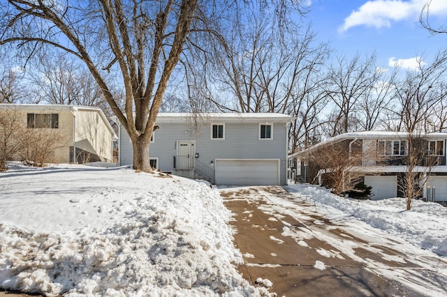 snow covered house with a garage