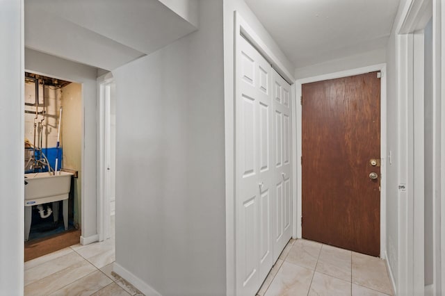 hall with light tile patterned floors and baseboards