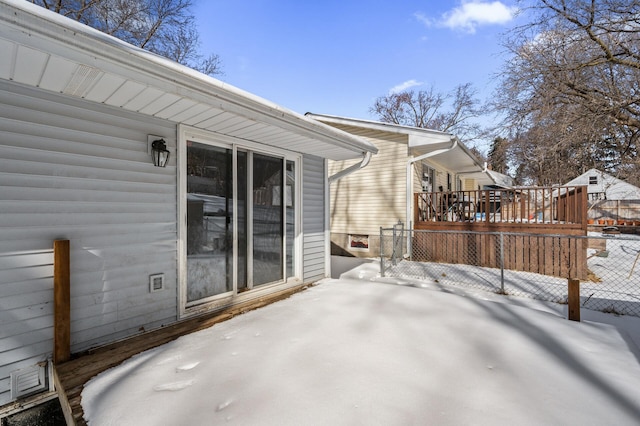 snow covered patio featuring fence