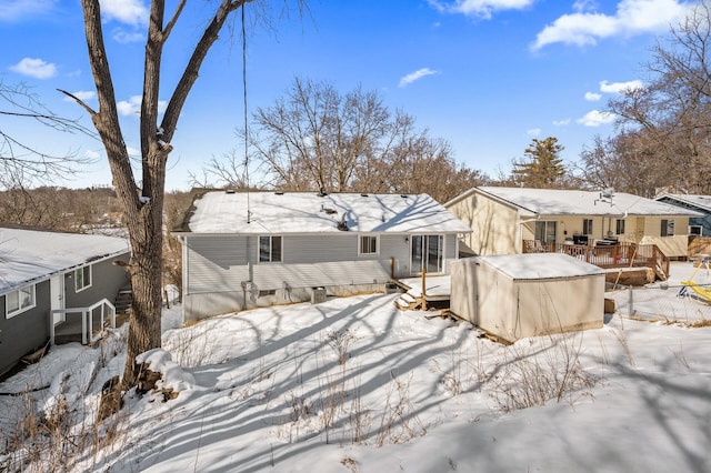 snow covered house featuring crawl space and a deck