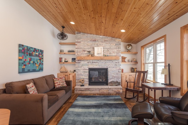 living room with lofted ceiling, recessed lighting, a stone fireplace, wood finished floors, and wooden ceiling