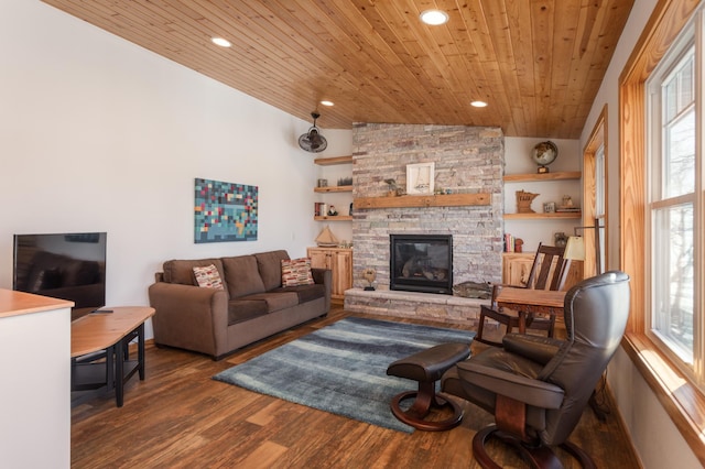 living area with recessed lighting, wood ceiling, vaulted ceiling, a stone fireplace, and wood finished floors