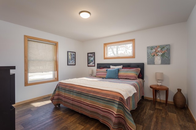 bedroom with baseboards and wood finished floors