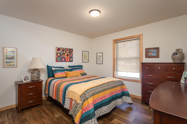 bedroom featuring dark wood-type flooring and baseboards