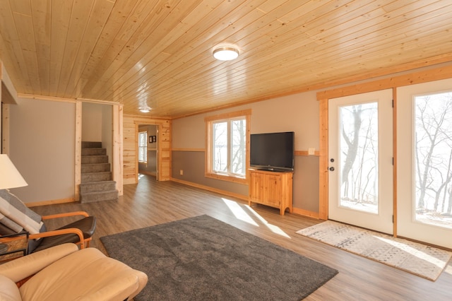 unfurnished living room featuring wood ceiling, stairway, and wood finished floors