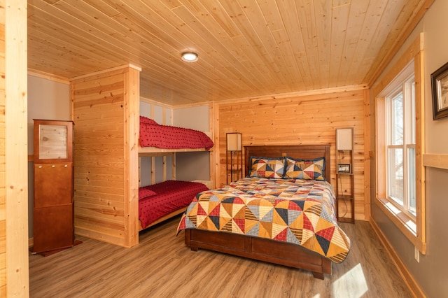 bedroom featuring wooden ceiling, wood walls, and wood finished floors