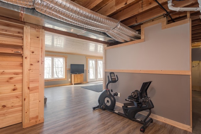 exercise room with wood finished floors and baseboards