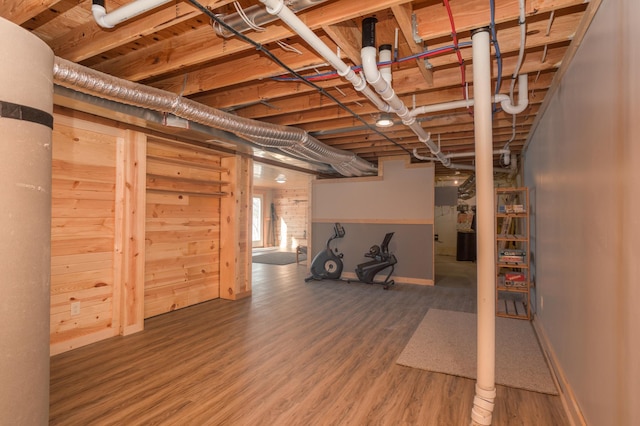 below grade area featuring baseboards and wood finished floors