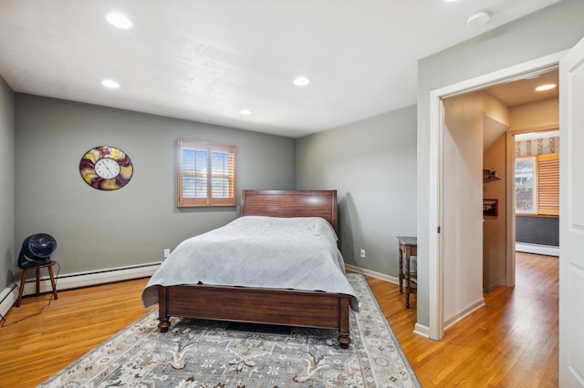 bedroom featuring baseboards, baseboard heating, wood finished floors, and recessed lighting