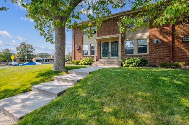 view of front of house with a front lawn and brick siding