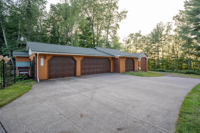 exterior space featuring driveway and fence