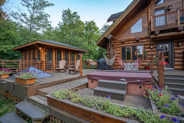 deck featuring a hot tub