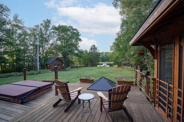 wooden deck with a covered hot tub and a yard