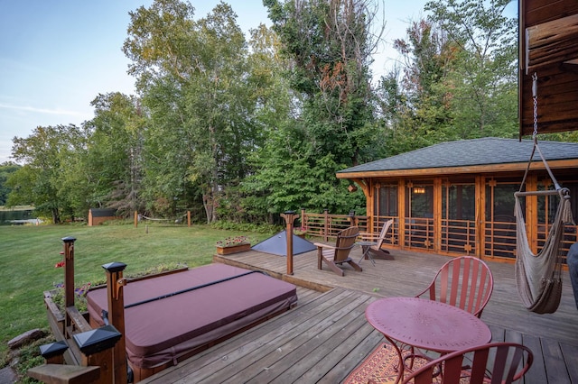 deck featuring a lawn and a covered hot tub