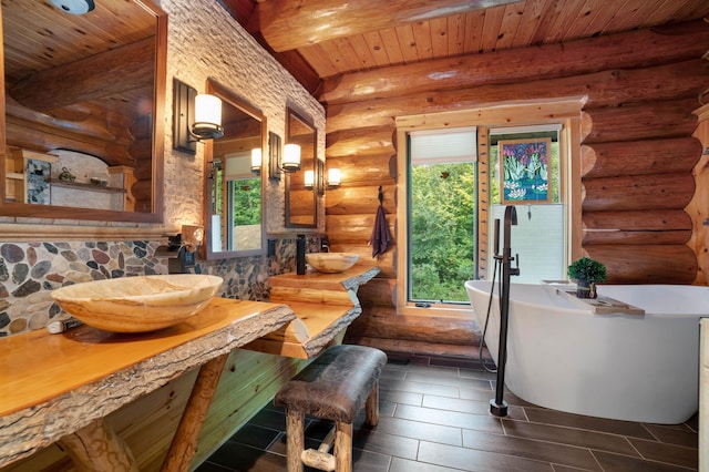 interior space featuring log walls, beam ceiling, and wood ceiling