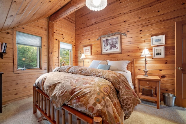 bedroom with vaulted ceiling, wooden ceiling, carpet flooring, and wooden walls