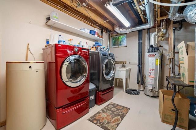 laundry area featuring laundry area, gas water heater, and separate washer and dryer