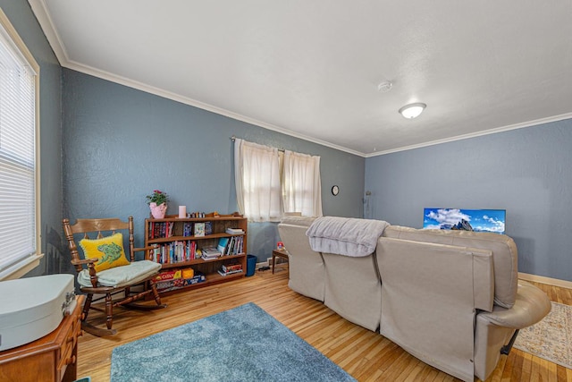 living area featuring wood finished floors and ornamental molding