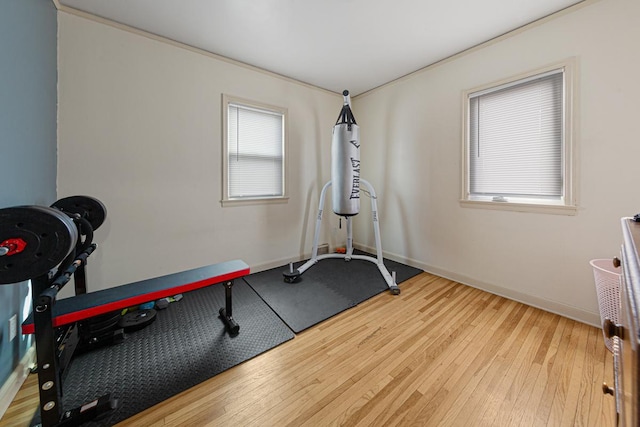 exercise room featuring baseboards and wood-type flooring