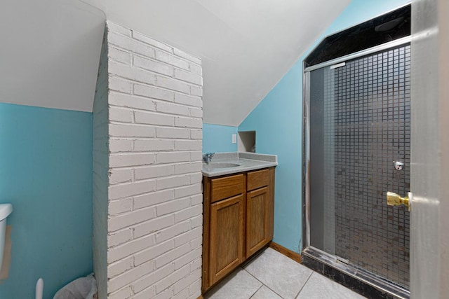 full bath with tile patterned floors, a stall shower, brick wall, lofted ceiling, and vanity