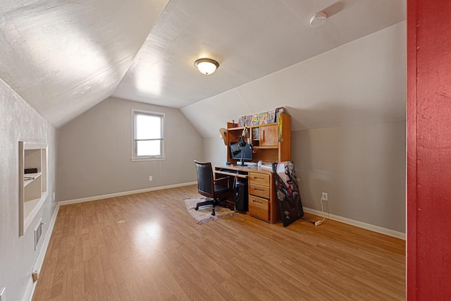 home office with vaulted ceiling, baseboards, visible vents, and light wood finished floors