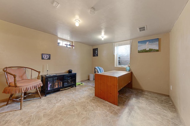 office space with visible vents, a healthy amount of sunlight, and baseboards