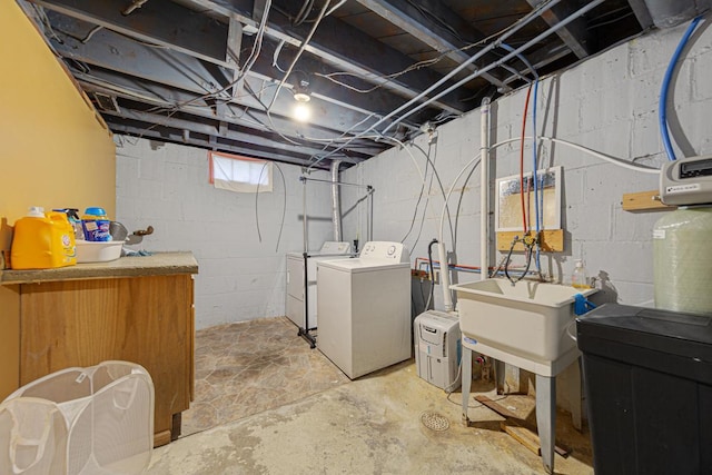 below grade area with a sink and washer and clothes dryer