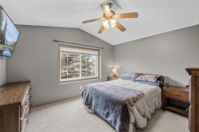 bedroom with lofted ceiling, ceiling fan, a textured ceiling, light carpet, and baseboards