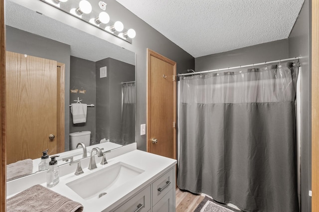 full bath featuring a textured ceiling, toilet, a shower with shower curtain, and vanity