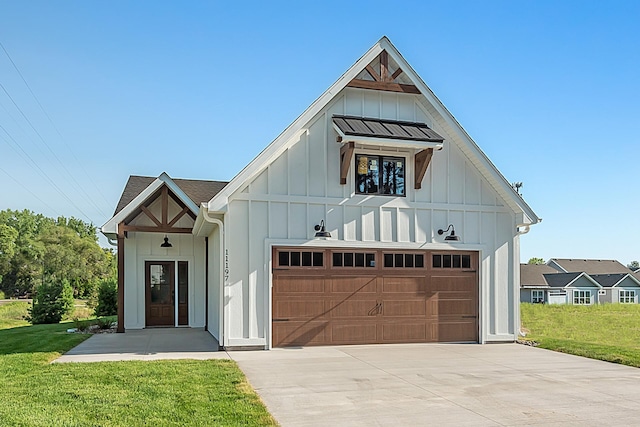 modern inspired farmhouse featuring board and batten siding, concrete driveway, a front lawn, and a garage