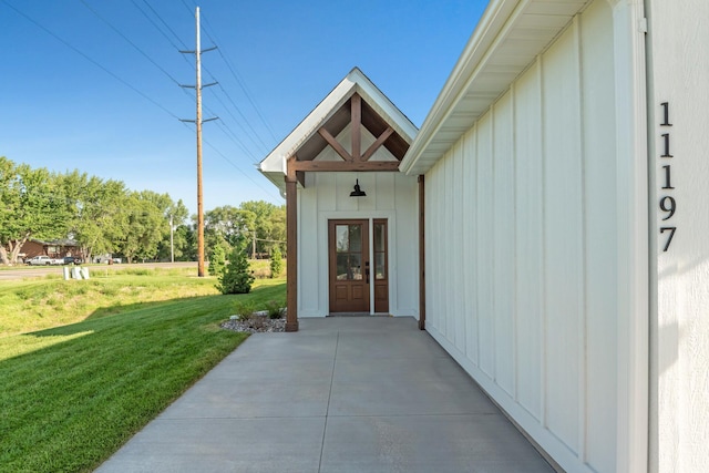 doorway to property featuring a lawn