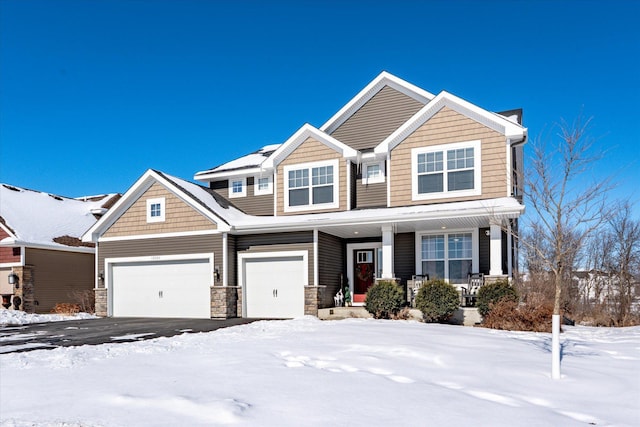 craftsman-style house featuring covered porch and driveway