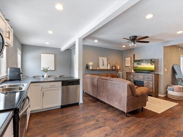 kitchen featuring stainless steel appliances, dark wood-type flooring, white cabinetry, and recessed lighting