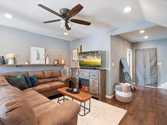 living room with ceiling fan, recessed lighting, wood finished floors, baseboards, and a glass covered fireplace