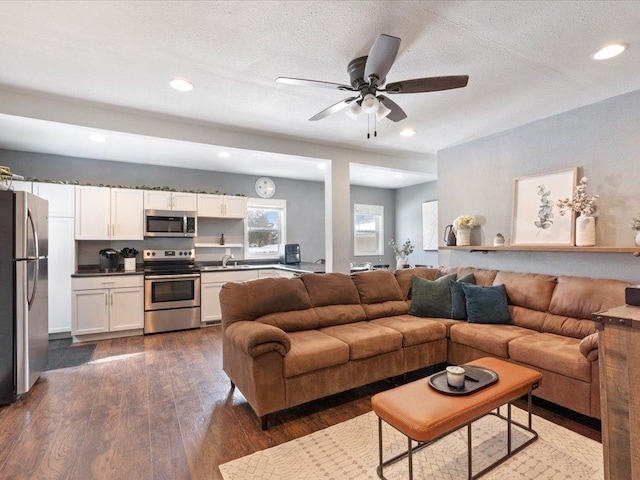 living area with dark wood-style floors, recessed lighting, a textured ceiling, and a ceiling fan