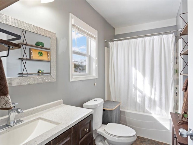 full bathroom featuring toilet, shower / bathtub combination with curtain, and vanity