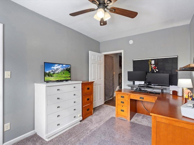 office space with carpet floors, ceiling fan, and baseboards