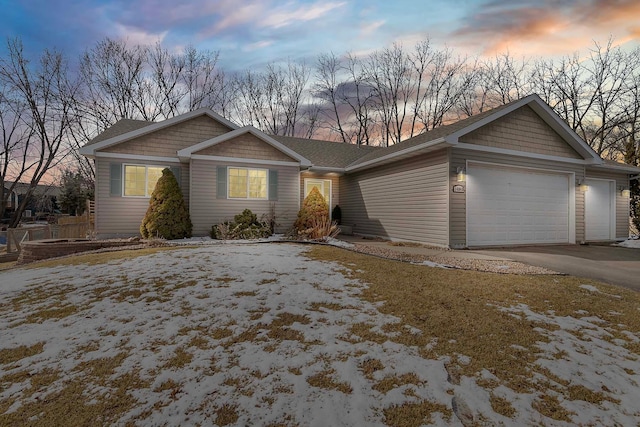 single story home with a garage and driveway